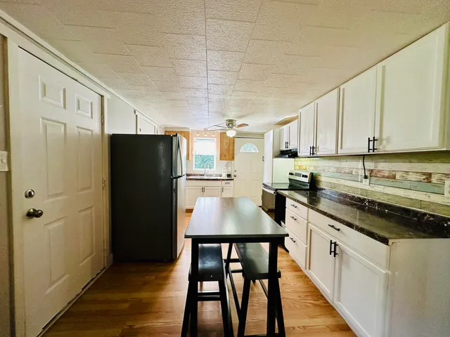 a view of yard with swimming pool and green space