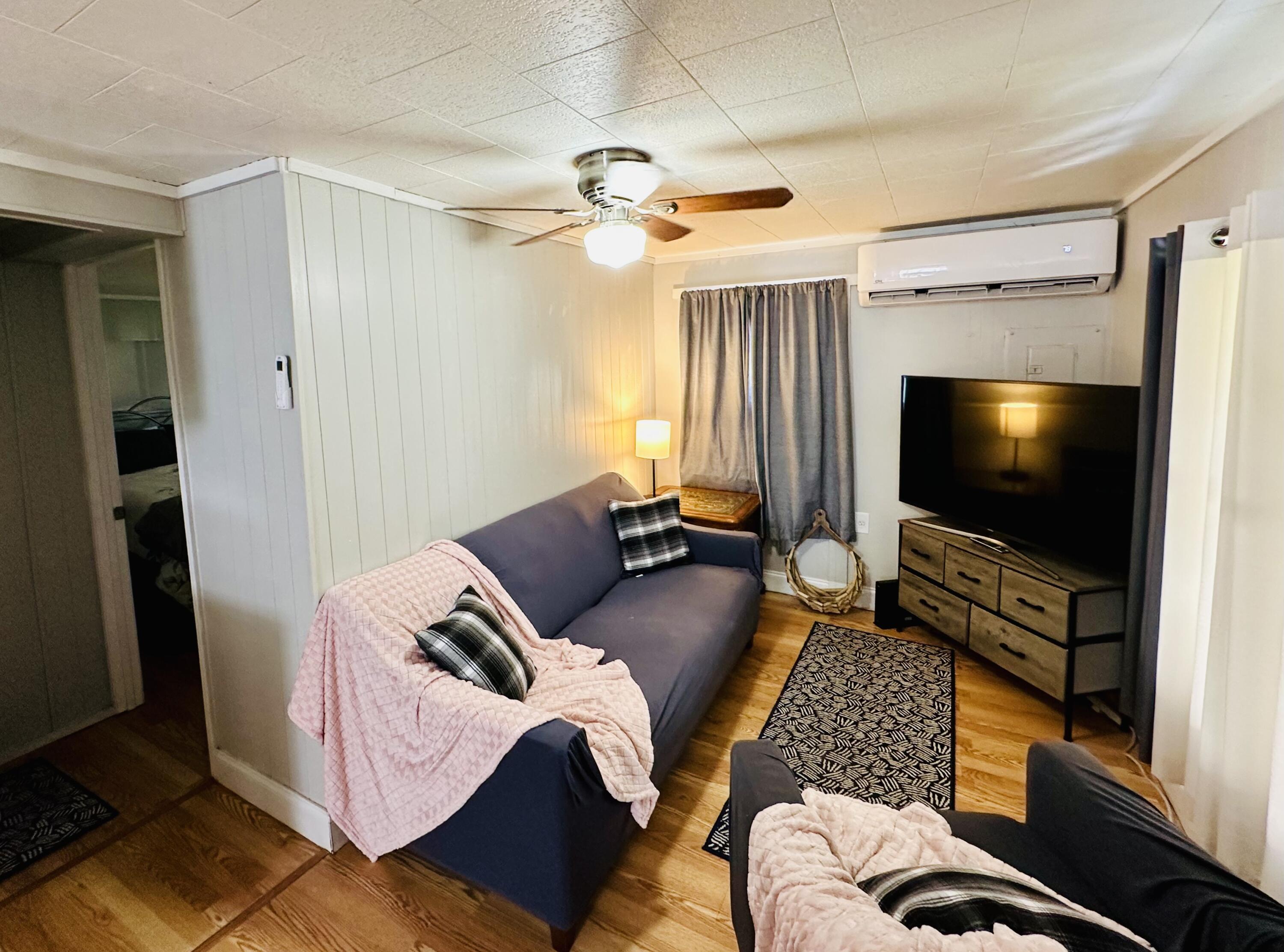 1104 Southwest 11th Street Okeechobee, FL 34974 - Photo 30 of 59 a living room with furniture and a flat screen tv
