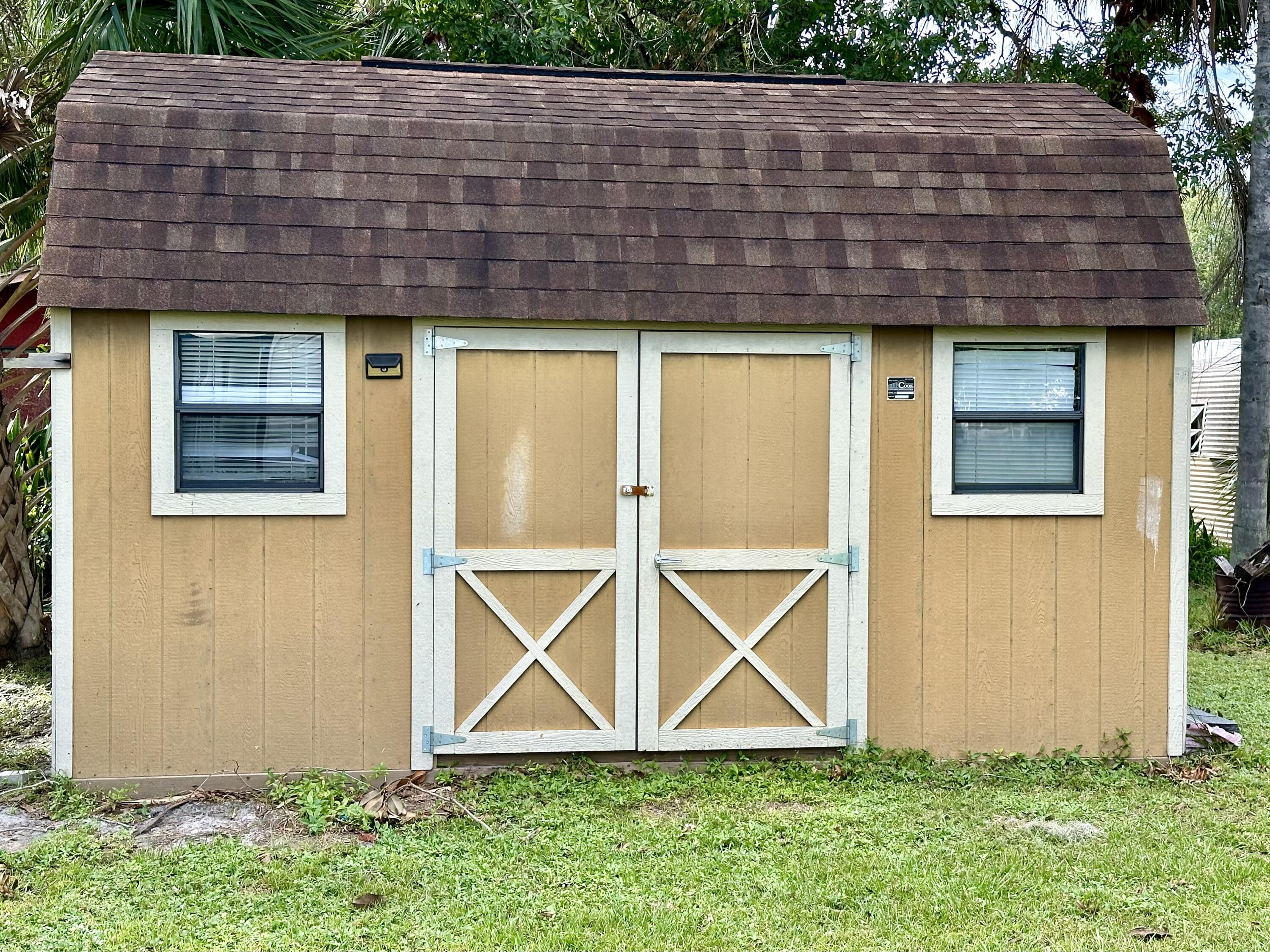 1104 Southwest 11th Street Okeechobee, FL 34974 - Photo 44 of 59 a view of brick house with a yard