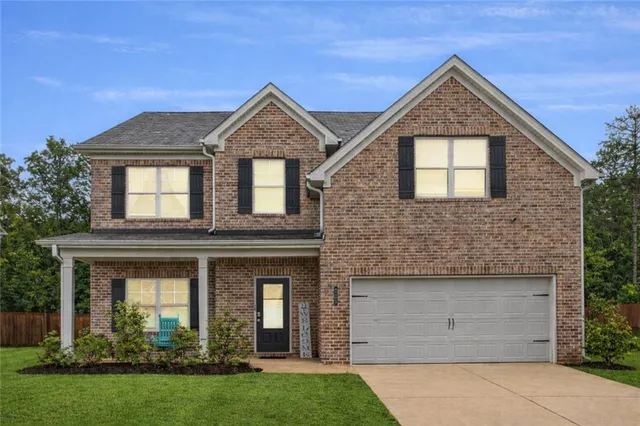 a front view of a house with a yard and garage