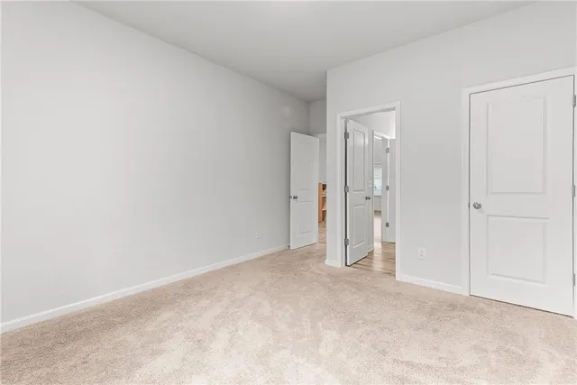 a spacious bedroom with a bed and a chandelier