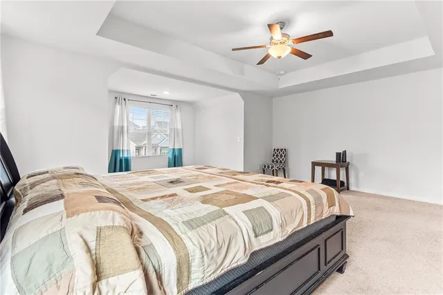 a spacious bedroom with a bed and a cabinets