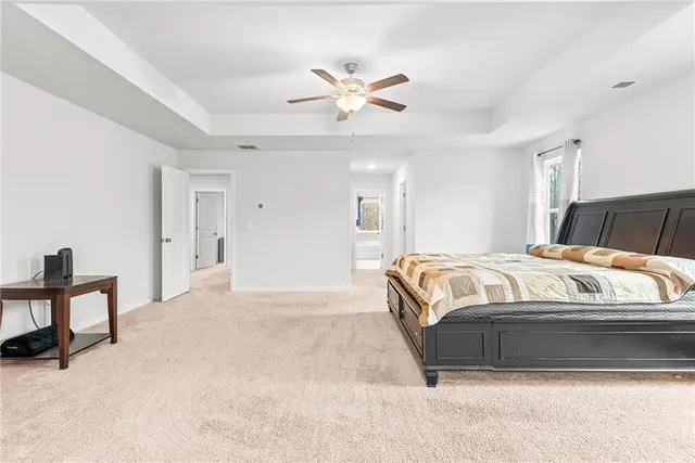 a bed room with a bed and a ceiling fan
