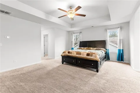 a bathroom with a granite countertop sink a large mirror and a bathtub