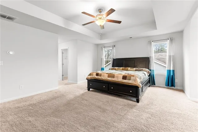 a bathroom with a granite countertop sink a large mirror and a bathtub