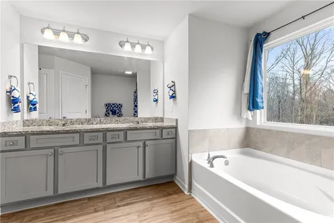 a view of walk in closet with clothes