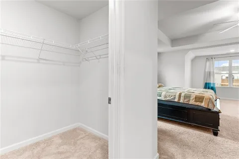 a bedroom with a bed and a bookshelf