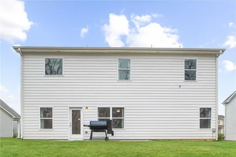 a view of a backyard with large trees