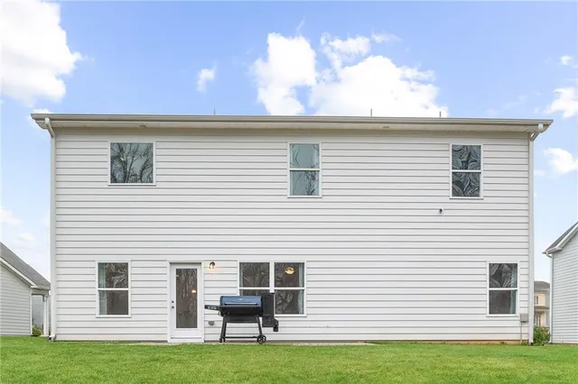 a view of a backyard with large trees
