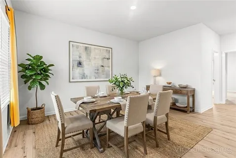 a dining room with furniture and window