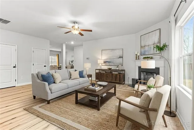 a living room with furniture and wooden floor