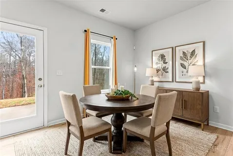 a dining room with furniture and window