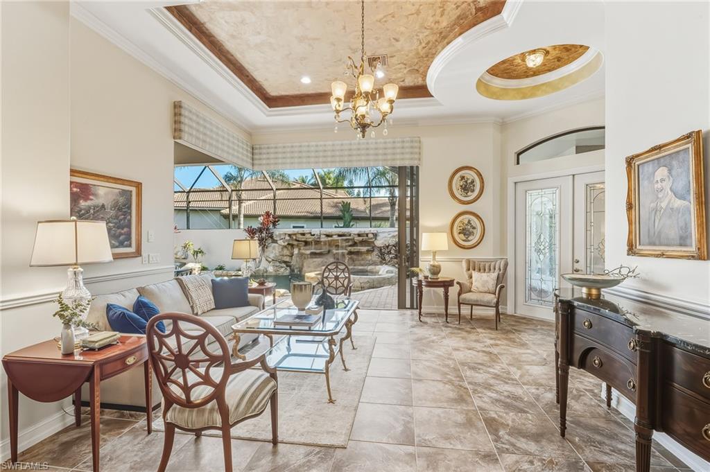 7749 Classics Drive Naples, FL 34113 - Photo 20 of 39 Living Room with view to pool and front door