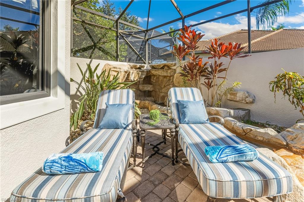 7749 Classics Drive Naples, FL 34113 - Photo 26 of 39 Chaise lounges with waterfall feature