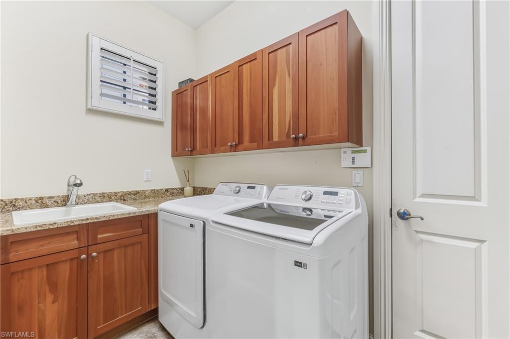 7749 Classics Drive Naples, FL 34113 - Photo 30 of 39 Laundry with storage utility sink