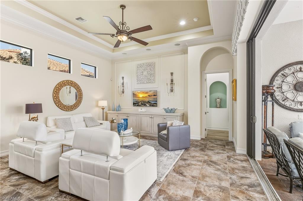 7749 Classics Drive Naples, FL 34113 - Photo 3 of 39 Family room with custom console, sliders open to pool