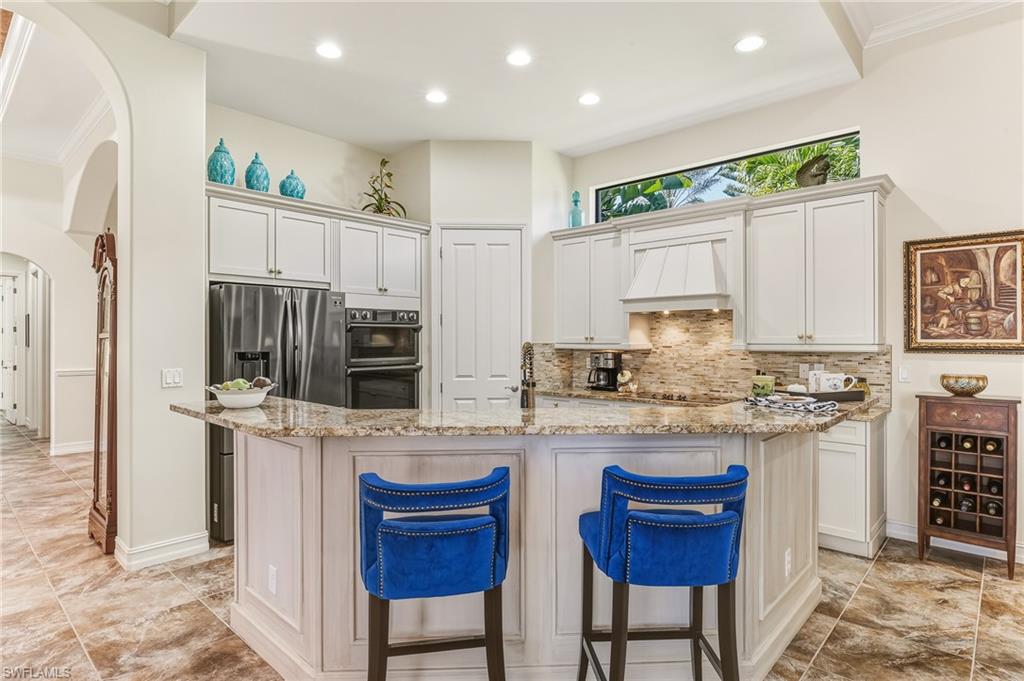 7749 Classics Drive Naples, FL 34113 - Photo 7 of 39 Kitchen with wrap-a-round island