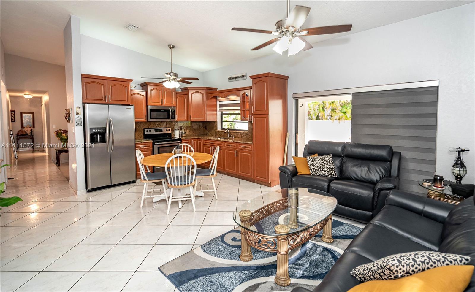 14695 Southwest 45th Street Miami, FL 33175 - Photo 21 of 33 a dining room with furniture a chandelier and wooden floor