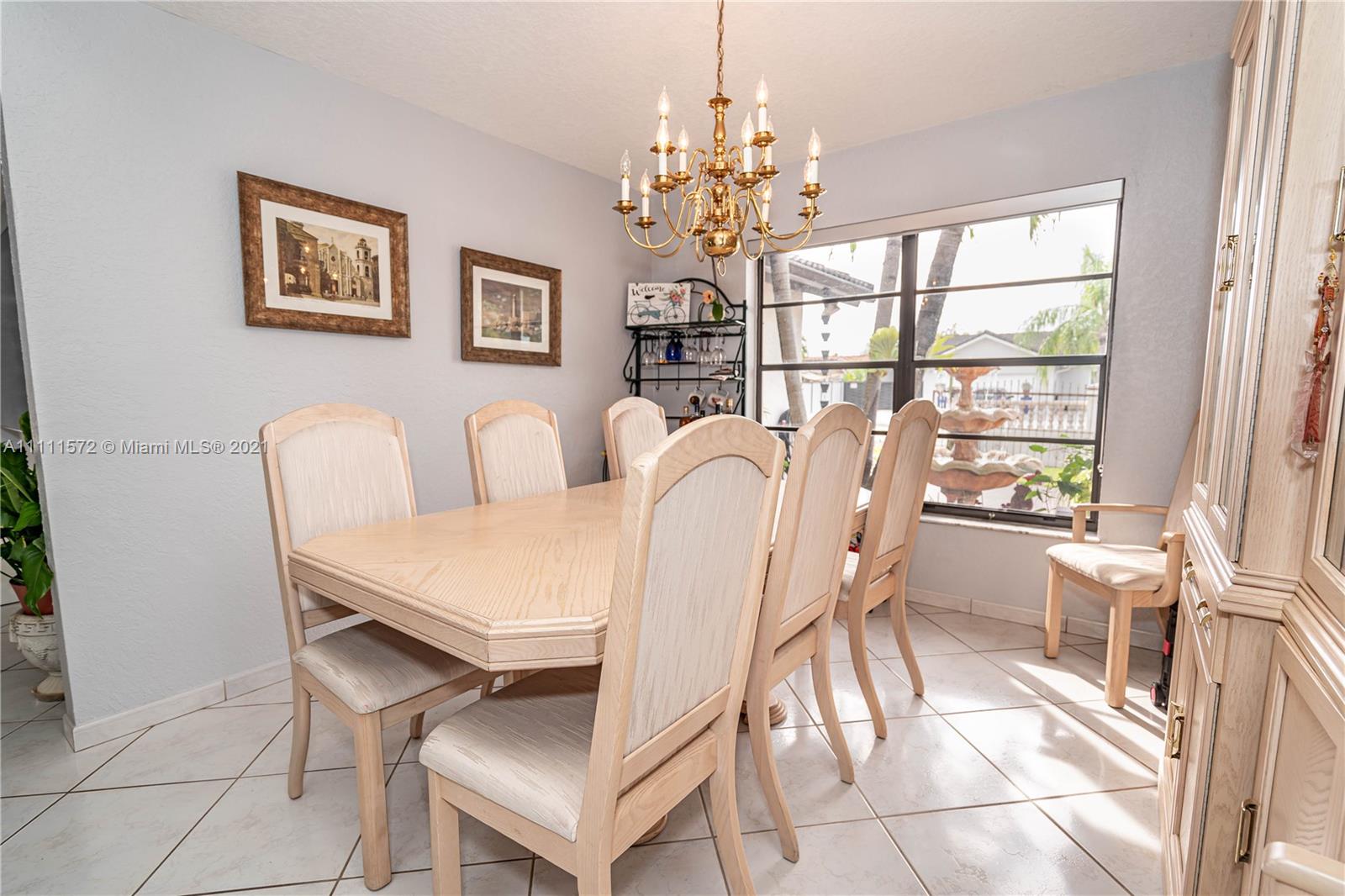 14695 Southwest 45th Street Miami, FL 33175 - Photo 23 of 33 a dining room with furniture a livingroom and chandelier