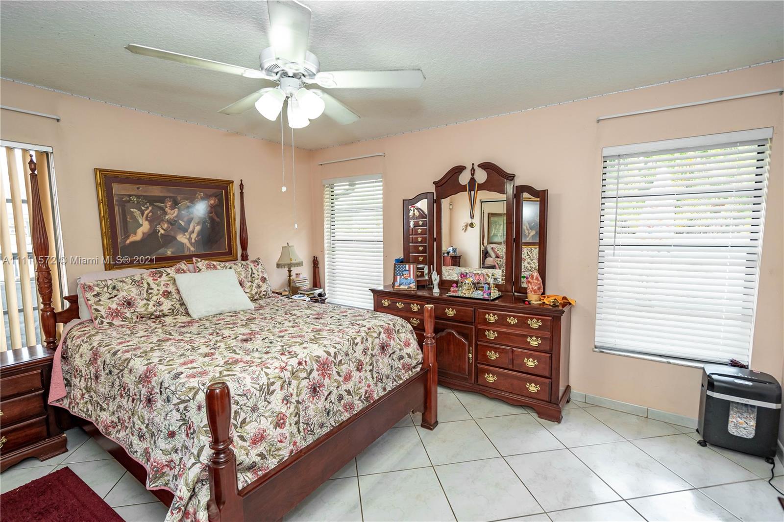 14695 Southwest 45th Street Miami, FL 33175 - Photo 29 of 33 a bedroom with a large bed and a chandelier