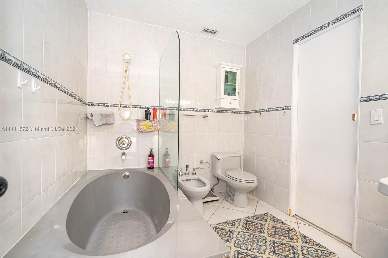 14695 Southwest 45th Street Miami, FL 33175 - Photo 30 of 33 a bathroom with a sink toilet and shower