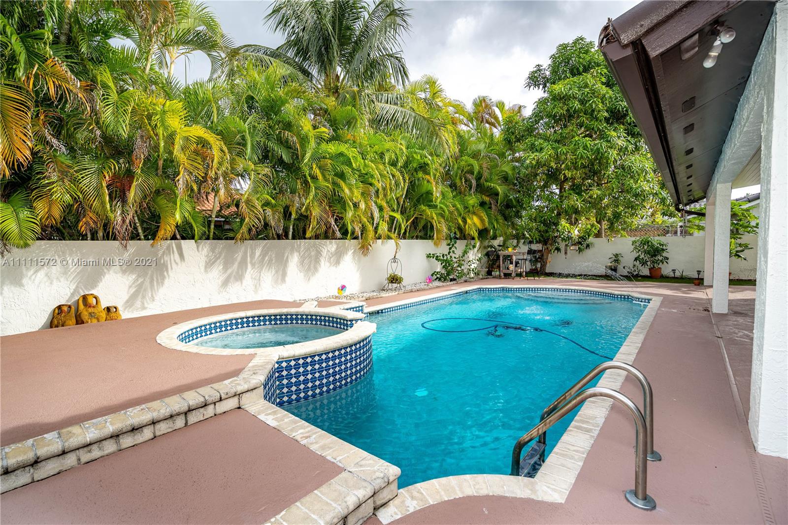 14695 Southwest 45th Street Miami, FL 33175 - Photo 5 of 33 a backyard of a house with table and chairs