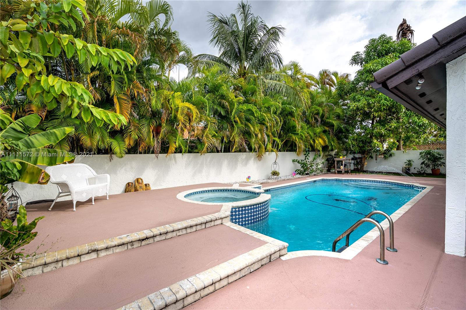 14695 Southwest 45th Street Miami, FL 33175 - Photo 8 of 33 a view of a chairs and table in a backyard