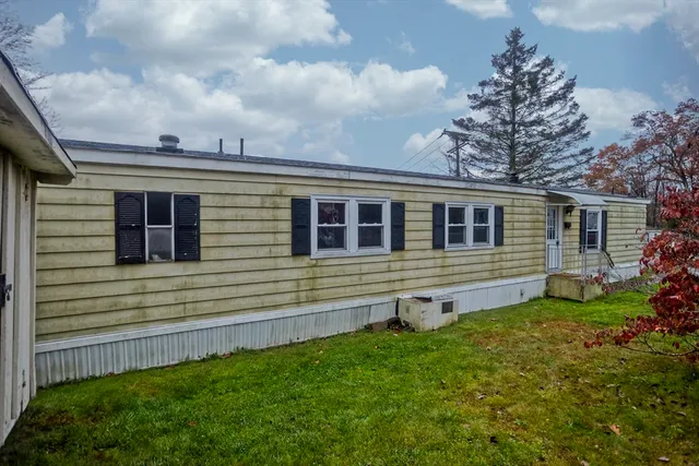 a view of a house with a backyard