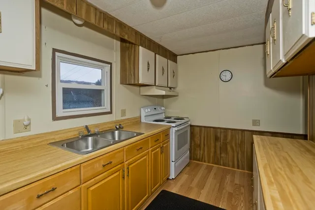 a kitchen with stainless steel appliances granite countertop a sink and cabinets