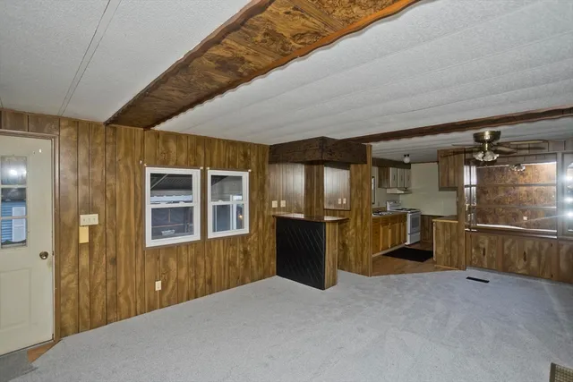 a view of a hallway with wooden cabinet and staircase
