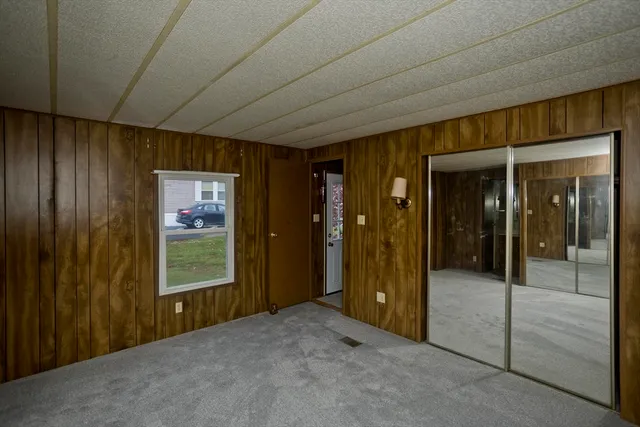 a view of a hallway with wooden shelves