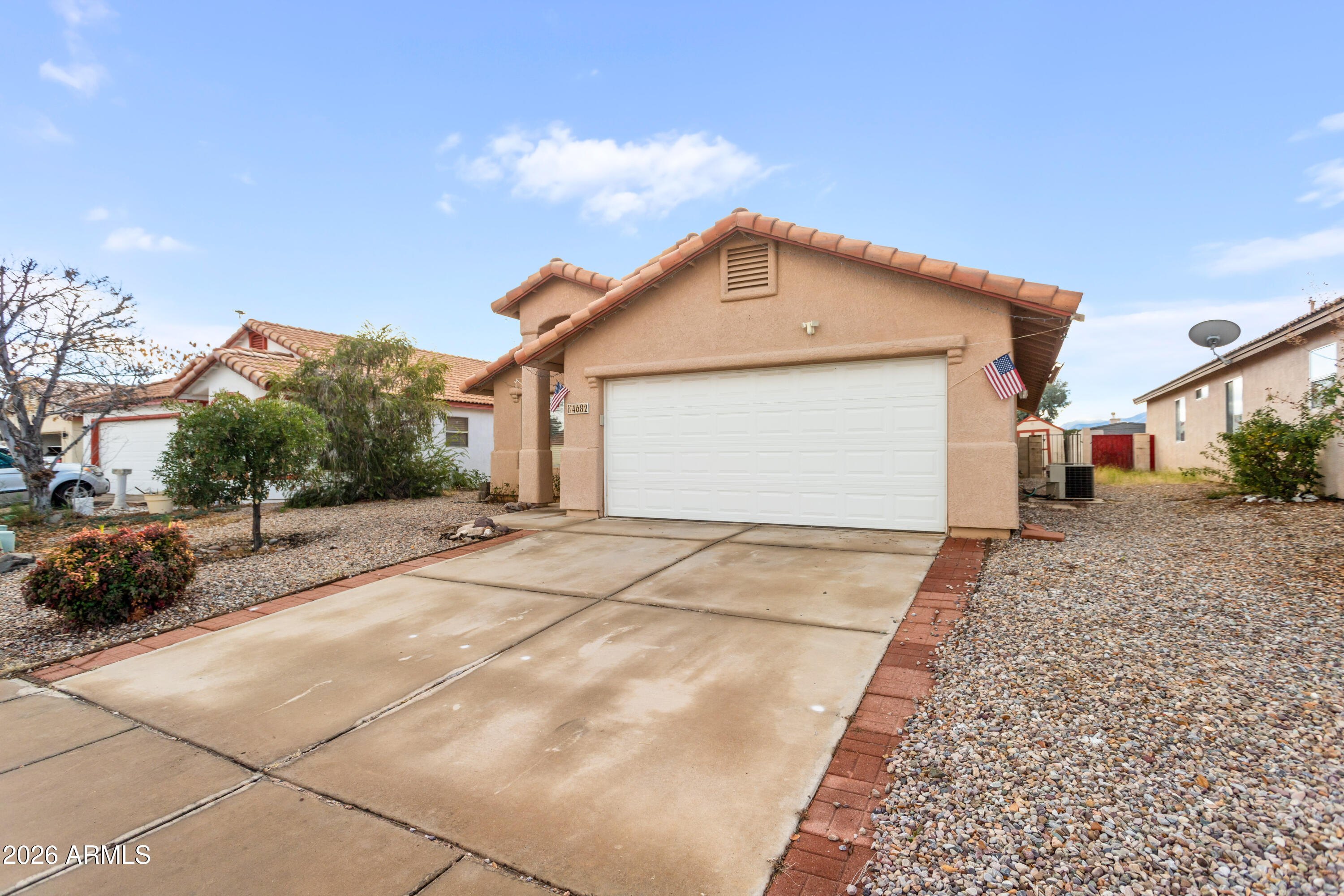 4682 Chaparral Loop Sierra Vista, AZ 85635 - Photo 3 of 28 a front view of a house with a yard and garage