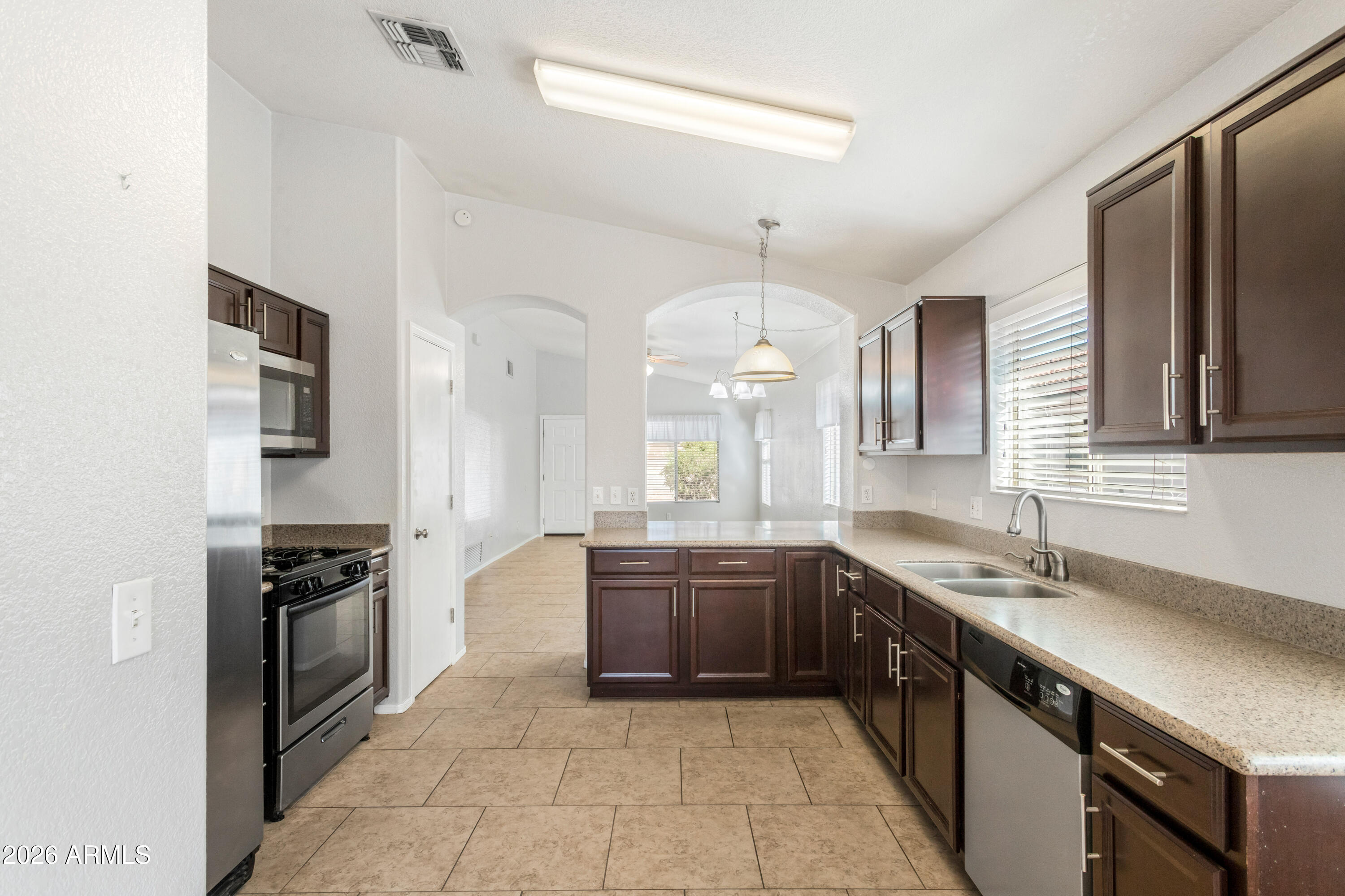4682 Chaparral Loop Sierra Vista, AZ 85635 - Photo 9 of 28 a large kitchen with granite countertop a stove and a sink