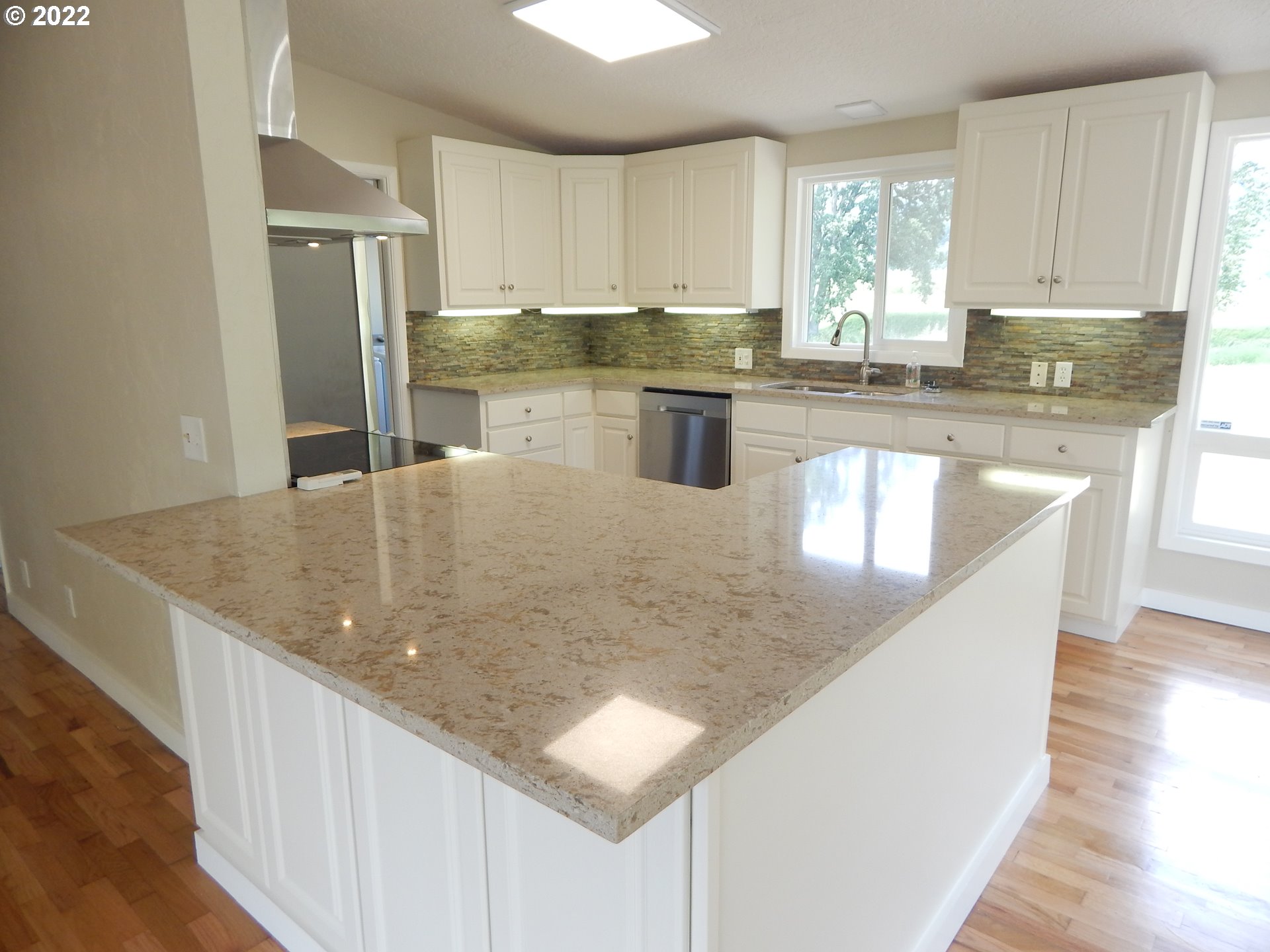 39321 Camp Creek Road Springfield, OR 97478 - Photo 12 of 32 a kitchen with stainless steel appliances granite countertop a sink a window and white cabinets