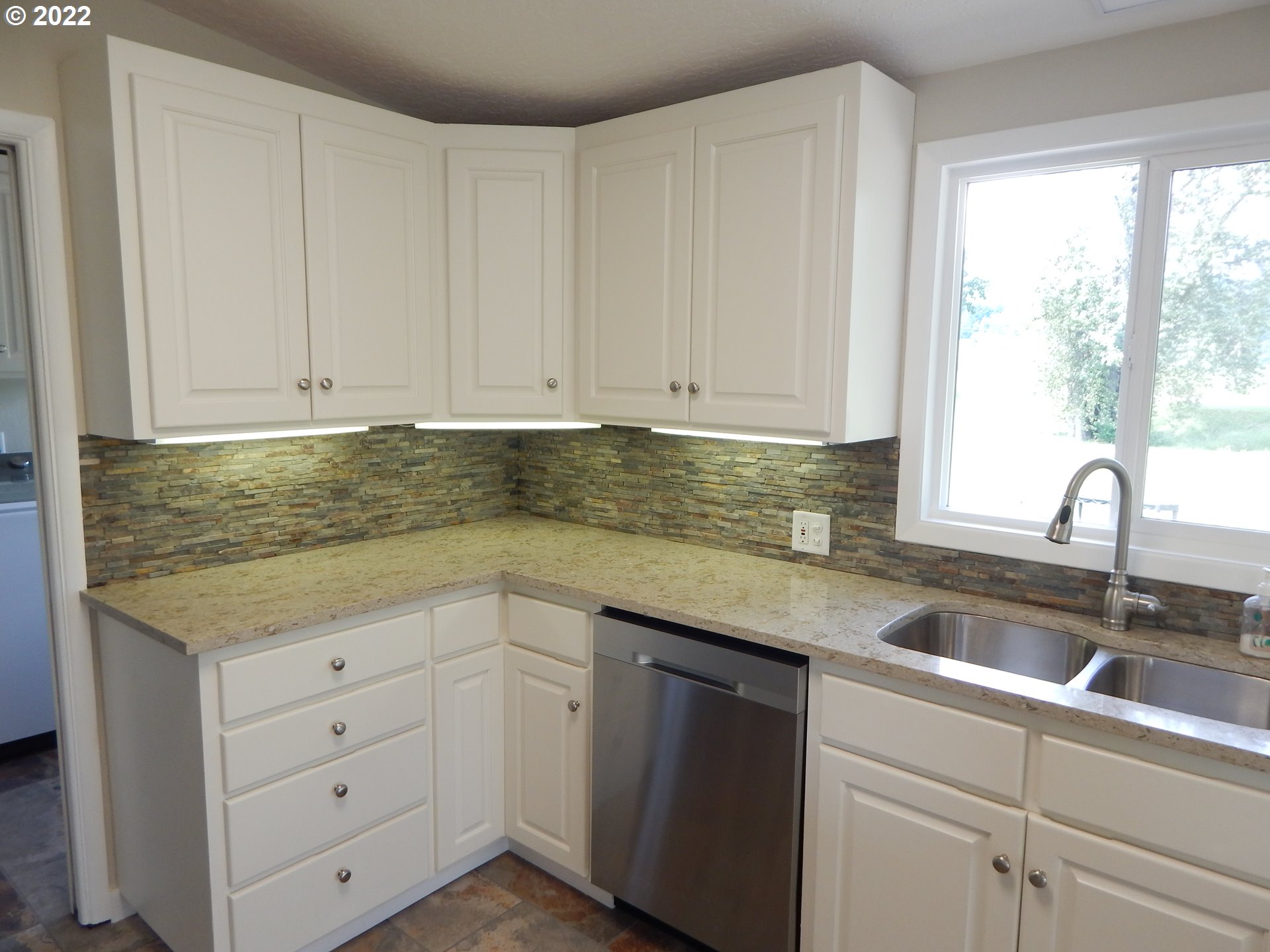 39321 Camp Creek Road Springfield, OR 97478 - Photo 13 of 32 a kitchen with granite countertop white cabinets and sink