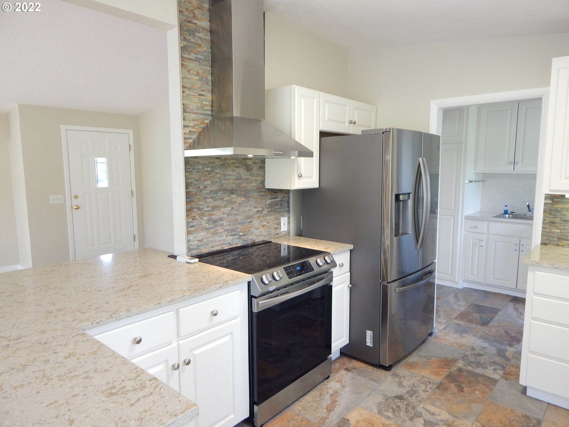 39321 Camp Creek Road Springfield, OR 97478 - Photo 16 of 32 a kitchen with a stove a refrigerator and a sink