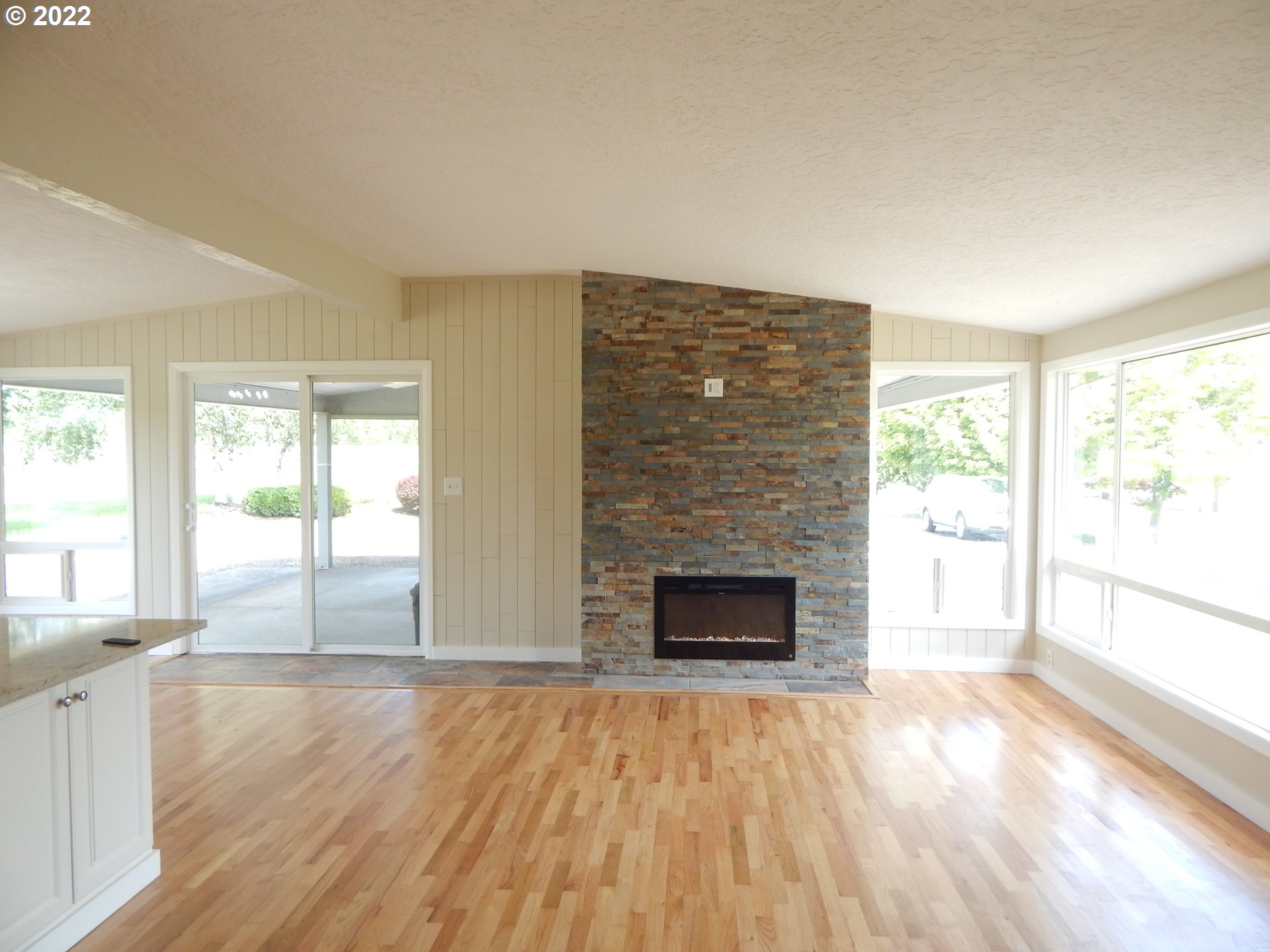39321 Camp Creek Road Springfield, OR 97478 - Photo 8 of 32 wooden floor fireplace and windows in an empty room