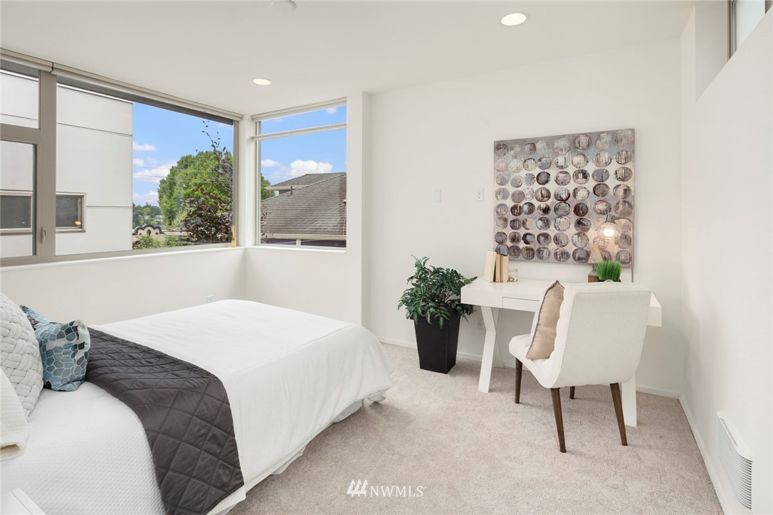 1829 24th Avenue, Unit A Seattle, WA 98122 - Photo 18 of 25 a bedroom with a large bed and a chair