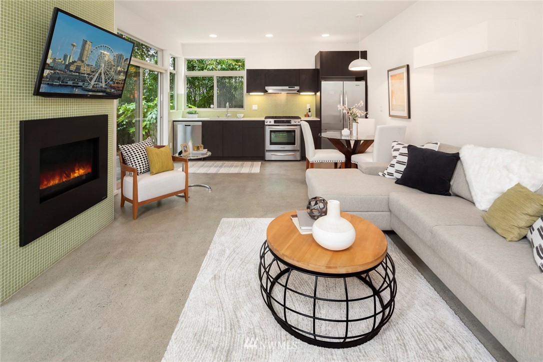 1829 24th Avenue, Unit A Seattle, WA 98122 - Photo 3 of 25 a living room with furniture a fireplace and a large window