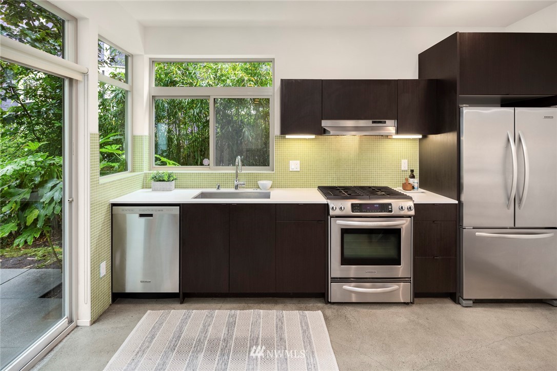 1829 24th Avenue, Unit A Seattle, WA 98122 - Photo 7 of 25 a kitchen with a refrigerator and a stove