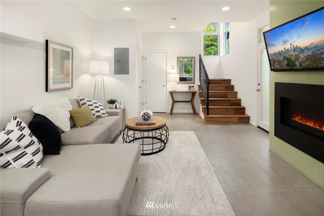 1829 24th Avenue, Unit A Seattle, WA 98122 - Photo 9 of 25 a living room with furniture and a fireplace