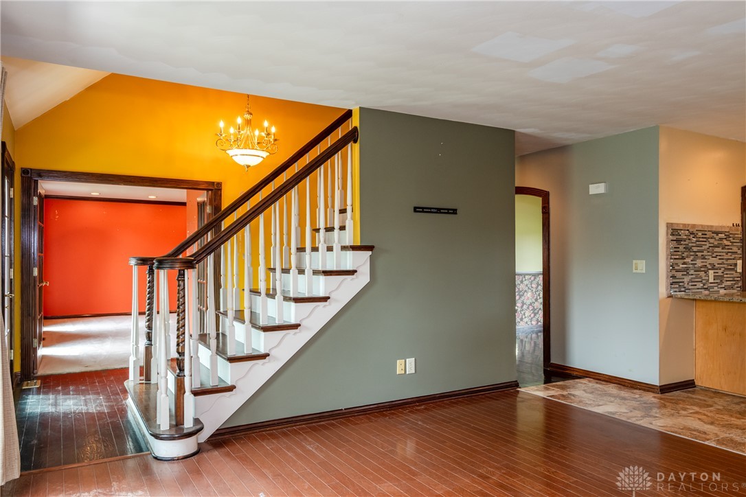 9981 Ridge Acres Lane Englewood, OH 45322 - Photo 27 of 73 This interior foyer features a grand staircase, offering a warm welcome and stylish flow.