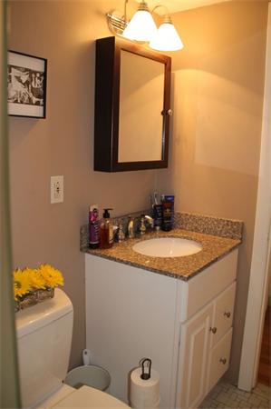 245 Kelton Street, Unit 11 Boston, MA 02134 - Photo 7 of 12 a bathroom with a granite countertop sink and a mirror