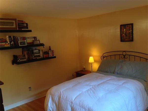 245 Kelton Street, Unit 11 Boston, MA 02134 - Photo 9 of 12 a bedroom with a bed and a lamp on dresser