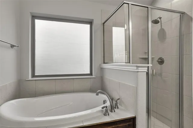 a white bath tub sitting next to a shower