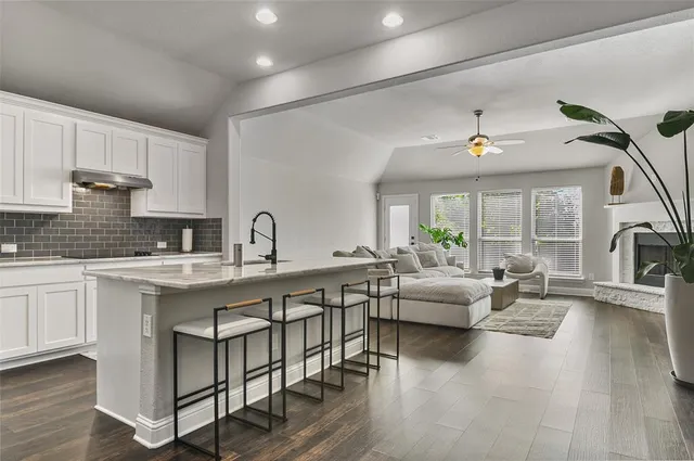 a kitchen with counter top space and living room