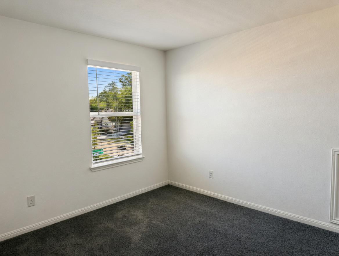 4002 Wynn Road Hutto, TX 78634 - Photo 11 of 29 Unfurnished room featuring dark carpet and baseboards