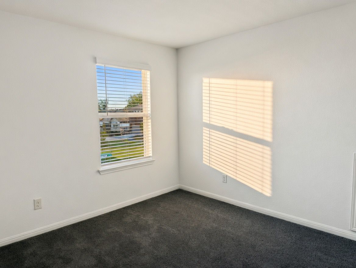 4002 Wynn Road Hutto, TX 78634 - Photo 12 of 29 Spare room with dark carpet and baseboards