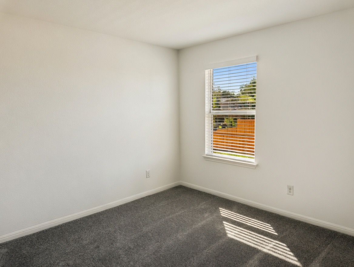 4002 Wynn Road Hutto, TX 78634 - Photo 13 of 29 Empty room with baseboards and dark colored carpet