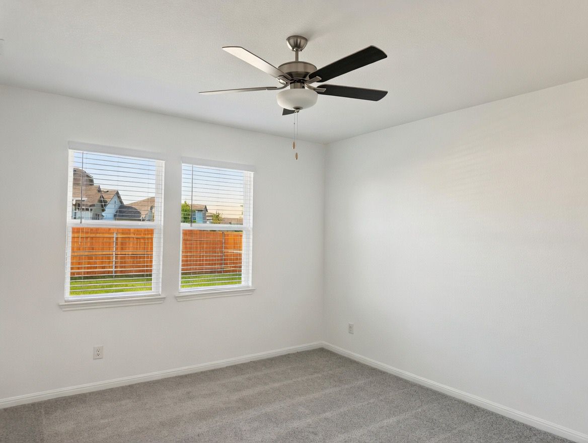 4002 Wynn Road Hutto, TX 78634 - Photo 17 of 29 Unfurnished room with carpet flooring and ceiling fan